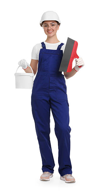 istock Young decorator with putty knife and paint bucket on white background 2227546142