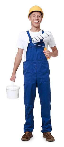 istock Young decorator with paint roller and bucket on white background 2227546146