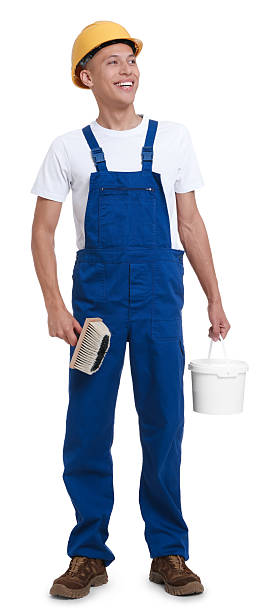istock Young decorator with paint brush and bucket on white background 2227546539