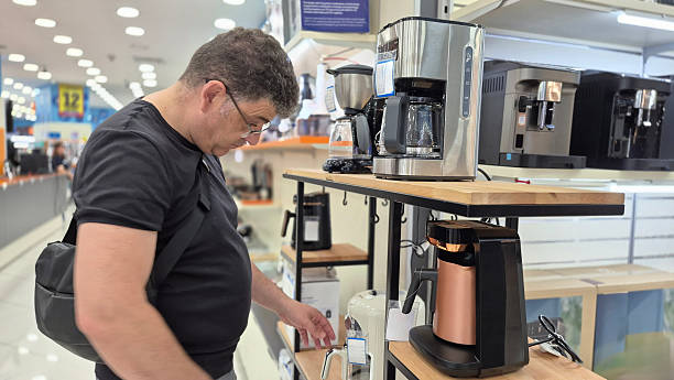 istock Man shopping for kitchen appliances in a modern retail store 2227550267