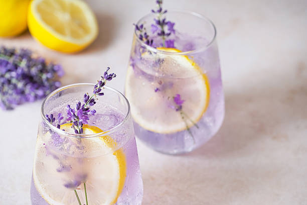 istock Refreshing lavender lemonade garnished with lemon slices and lavender sprigs on a marble countertop 2227553429