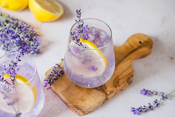 istock Refreshing lavender lemonade with lemon slices served on a wooden board in a bright setting 2227553490