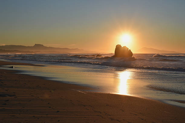 istock Sun setting behind a rock formation on Ilbarritz beach 2227553562