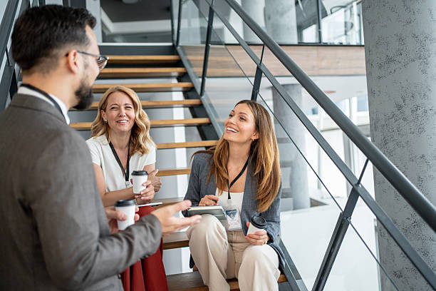 istock Business people chatting on stairs during coffee break 2227556011