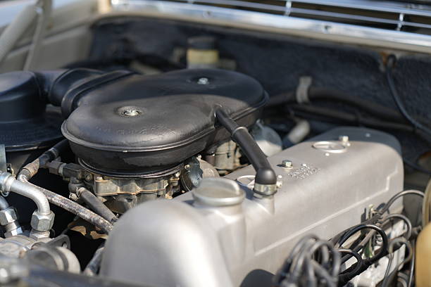 Detailed close-up of car engine components in an automotive workshop, showcasing engineering precision and mechanical elements. Ideal for themes of automotive maintenance and performance.