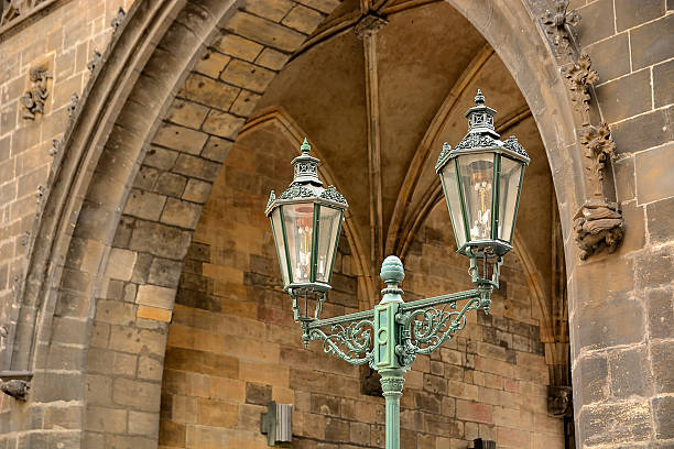 A lamp sconce on a colorful worn old building in Prague, Czech Republic