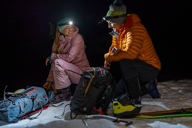 istock Young Couple Preparing for Ski Mountaineering Expedition Under Starry Night 2227556437