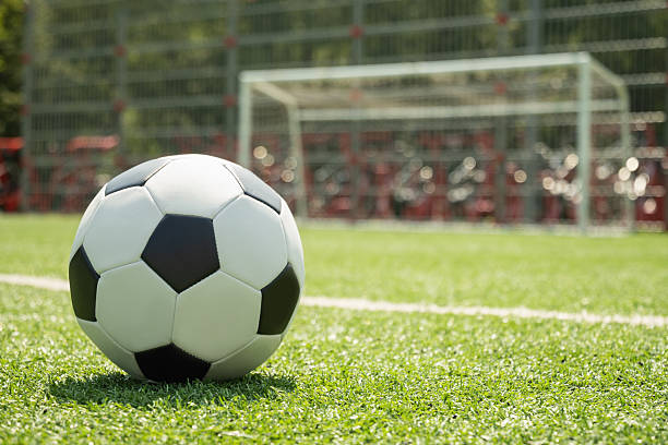 istock Soccer Ball on Field in Front of Goal Post 2227558034