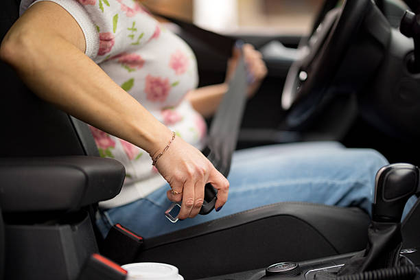 istock Woman fastening seat belt while driving a car 2227558724