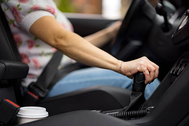 Woman shifting gears while driving a car