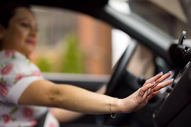 istock Woman adjusting car radio while driving 2227558739