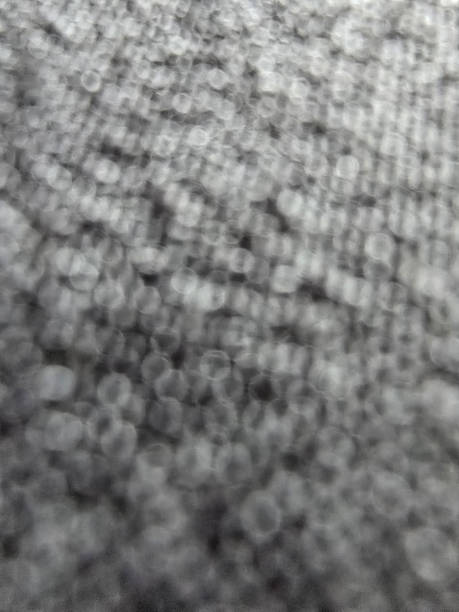 istock image features close up view of textured surface with blurred effect, showcasing pattern of small circles and varying shades of gray. This abstract representation evokes sense of depth and 2227561720