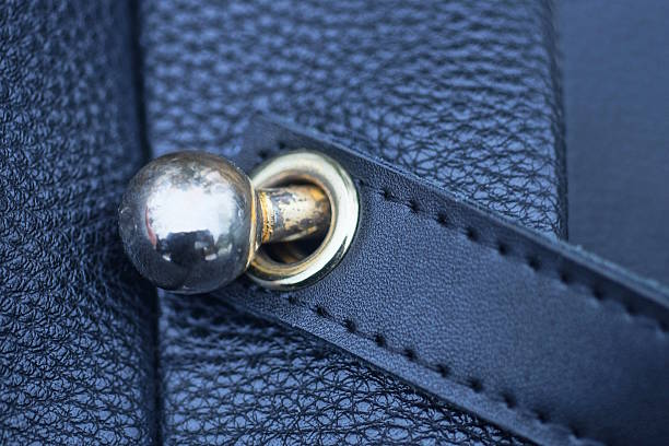 istock yellow metal latch with a ring on a black leather bag 2227562649