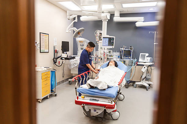 istock Hospital Room: Doctor Examining Patient on Stretcher 2227564709