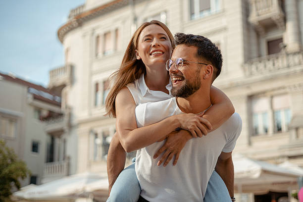istock Young Couple Having Fun with Piggyback Ride in Summer Sun 2227565329