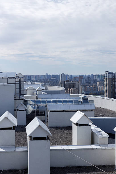 istock A Panoramic View of Urban Rooftops Surrounded by Modern High-Rise Buildings and a Beautiful Cloudy Sky 2227565376