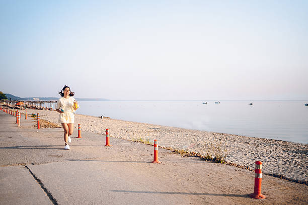 A young woman running on the sea.