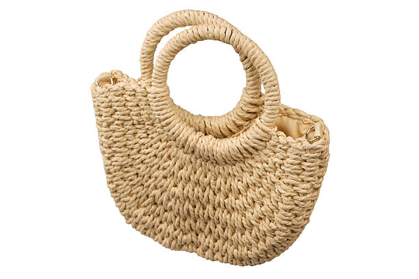 istock A beige straw bag isolated on a white background. 2227565987