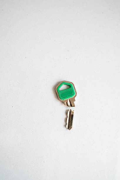 Two metal keys and a key fob lie on a soft green fabric, creating a sense of security and comfort