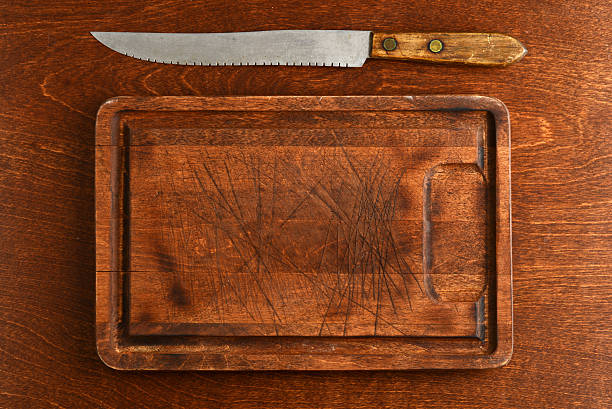 high angle view old wood cutting board with knife