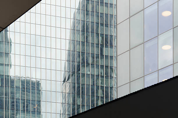 istock Modern green glass buildings create a striking urban skyline with multilayered reflections. 2227572154