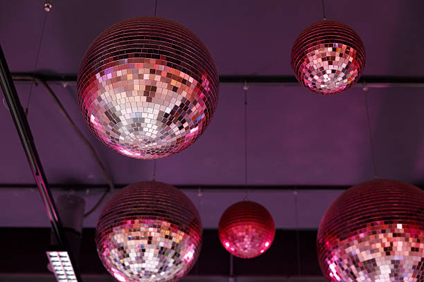 istock Shimmering Disco Balls Hanging from the Ceiling in an Elegant Setting, Reflecting Light in an Array of Colors, Creating a Festive Atmosphere for Celebrations and Dance Parties 2227575624
