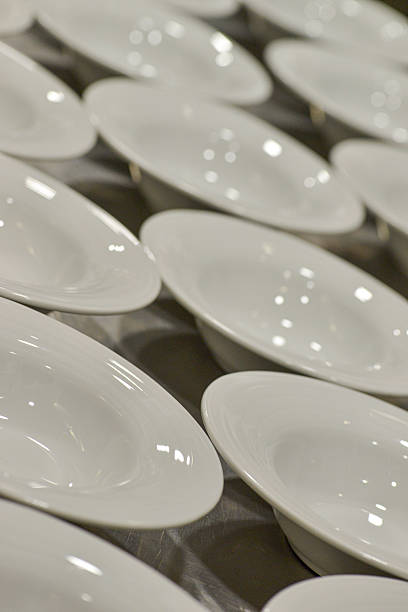 istock Shiny white ceramic bowls arranged neatly on stainless steel surface, waiting before restaurant kitchen service begins 2227576529