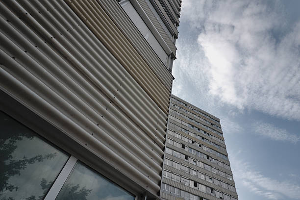 istock Modern office building with blue sky and white clouds in the background. 2227582460