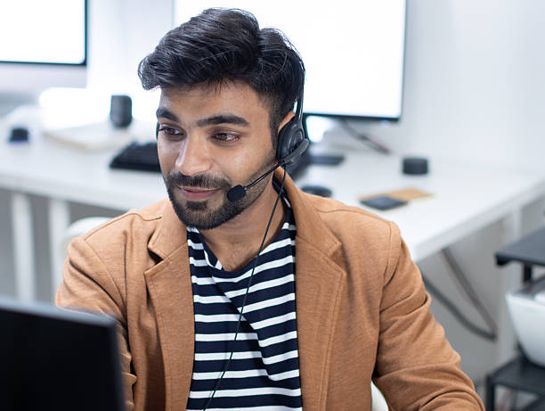 istock Indian Customer Support Agent Wearing Headset While Talking During Online Video Call in Modern Office 2227582982