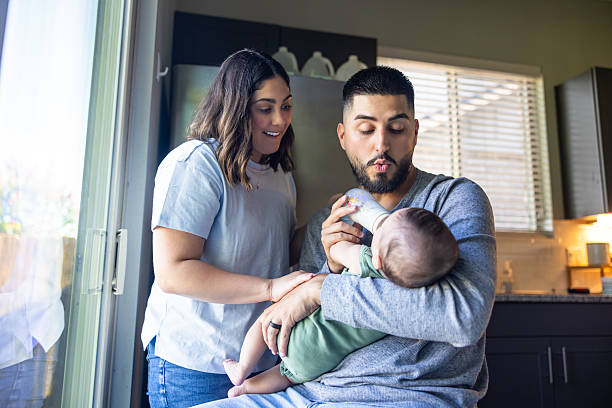 New mom and dad feeding their baby