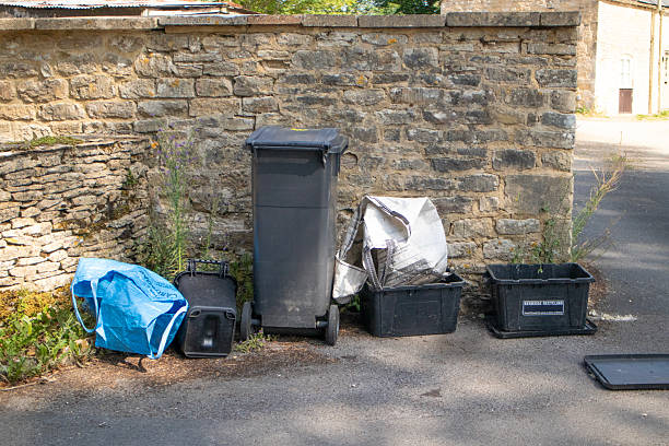 istock Empty water and recycling bins just after collection by bin men by a Cotswold stone wall 2227583339