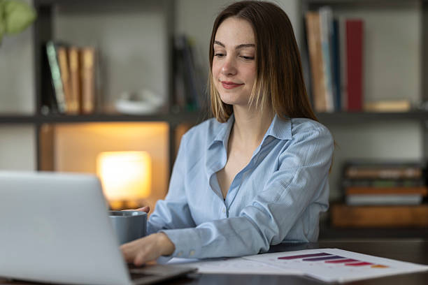 istock Young businesswoman working from home, drinking coffee and using laptop 2227585078
