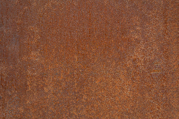 Close-up of rusty metal texture showing natural corrosion and weathered patterns. Image for backgrounds, industrial design projects, or creative concepts illustrating decay and aging surfaces