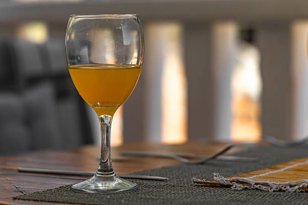 istock Orange juice poured into a glass placed on the table, 2227595421