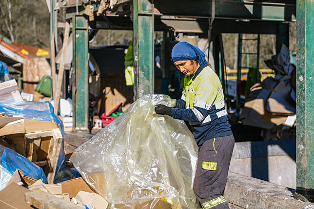 istock Waste management worker organizing plastic materials for recycling 2227596414