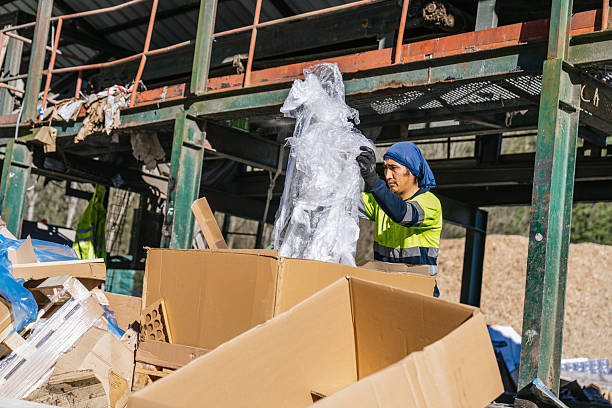 istock Waste management worker organizing plastic for recycling in a cardboard box 2227596726