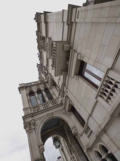 istock distant plan of a Renaissance-style building with a blue ceiling from which hangs a classical-style lamp. The façade is beige and the door is black with gold decoration 2227597829