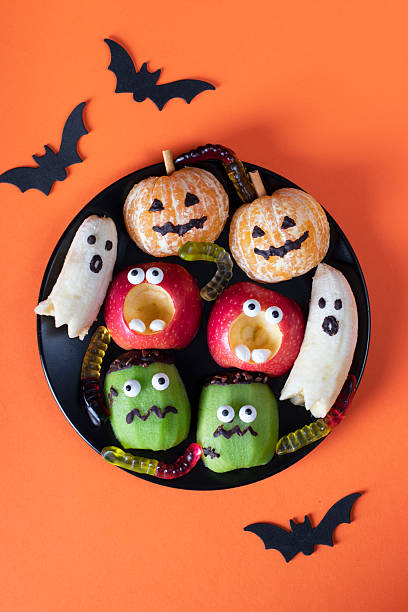 istock Fruit monsters and ghosts for a Halloween party, Top view 2227598679