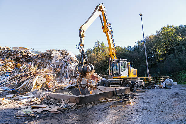 istock Excavator loading wood waste for recycling in a landfill 2227599751