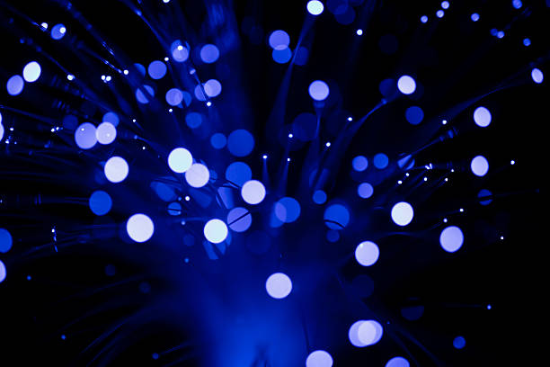 istock Fiber optic cables glowing blue .  bokeh light spots 2227600099