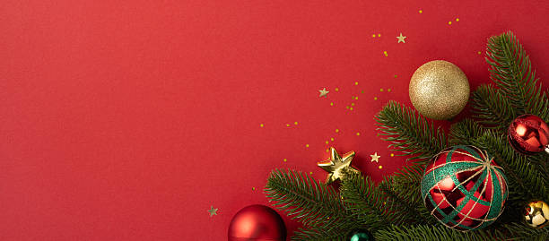 istock Elegant festive composition featuring colorful Christmas ornaments with evergreen branches on a crimson background, perfect for holiday themes and seasonal celebrations 2227600302