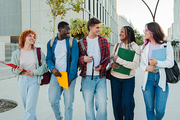 istock Group of Diverse Students Joyfully Walking and Talking Together While Engaging in Lively Conversation and Sharing Academic Materials at University Campus Filled with Friendship and Laughter 2227601338