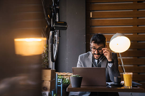 istock Freelancer in cafe having video call with headphones in 2227603735