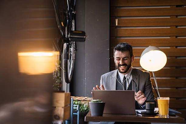 istock Businessman laughing on laptop video call 2227603764