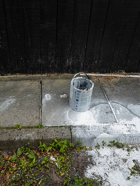 istock An empty paint bucket, with paint splattered on the ground around it 2227604317