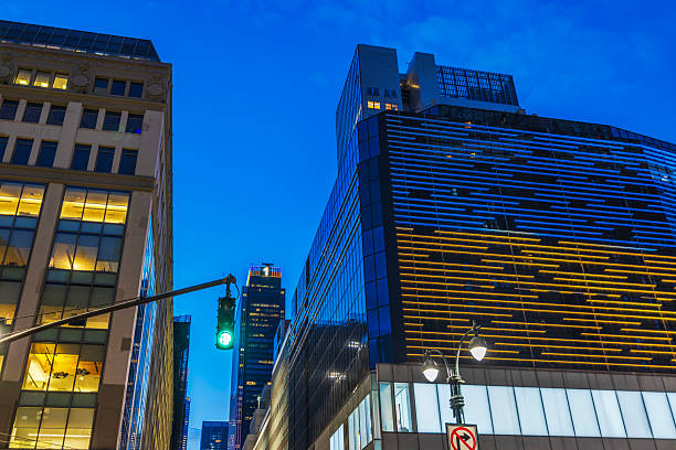 istock Modern glass skyscraper with glowing facade lines and traffic light against evening sky in New York. New York. USA. 2227606019