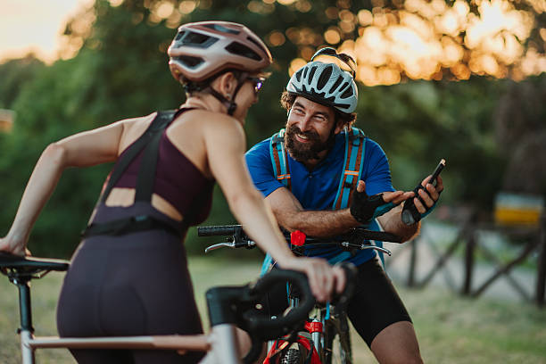 istock Cyclists enjoying a break and checking their phone during sunset ride 2227606758