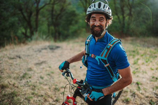 istock Smiling cyclist taking a break in the woods during golden hour 2227606796
