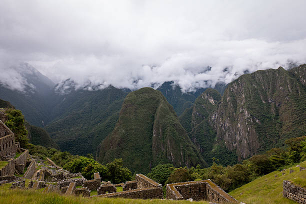 View of the Andes and the valley to Machu Picchu village. Ancient Inca city of Machu Picchu in the Andes. Peru. Clouds and mountains in the background. City in mystical clouds. Peru. South America. Latin America.