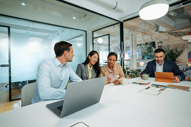 istock Colleagues having team meeting in boardroom discussing ideas 2227607183